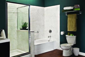 Captivating bathroom renovation with lush green walls, creating a refreshing and serene atmosphere. The focal point is a modern bathtub, complemented by a stylish shower with contemporary fixtures. The toilet seamlessly blends into the design, contributing to the harmonious and sophisticated aesthetic of the space. Fall into savings with EZPro Baths Express!